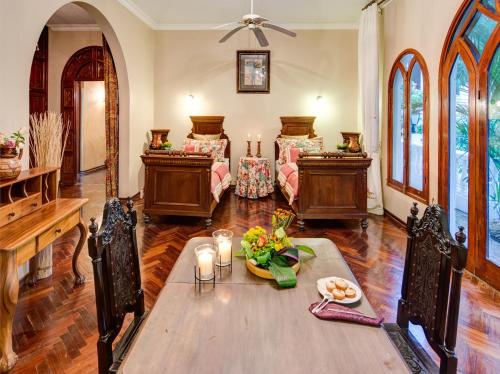 a living room with a table with candles and chairs at El Castillo de Esparza in Esparza
