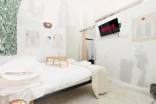 a room with a bed with a sign on the wall at Centro Torino - Chambre Incanto - by Cesare Marretti in Turin