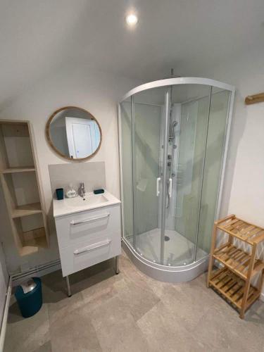 une salle de bain avec une douche avec un lavabo et un miroir dans l'établissement Le Clos des galets, à Audresselles
