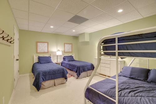 two bunk beds in a room with blue beds at Lakefront Lineville Retreat with Private Dock! in Lineville