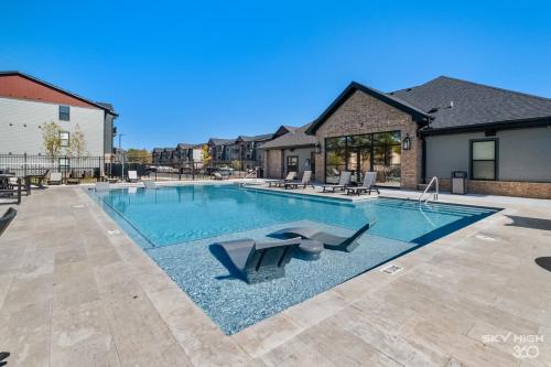 a swimming pool in the middle of a house at Modern Apt W Pool, Gym & Free "p"prime Location in Rogers