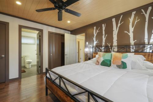 a bedroom with a bed and a ceiling fan at Luxurious Poconos Retreat - Hot Tub, Sauna, Games in East Stroudsburg