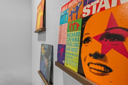 a group of posters on a wall in a room at Modern Apt W Pool, Gym & Free "p"prime Location in Rogers