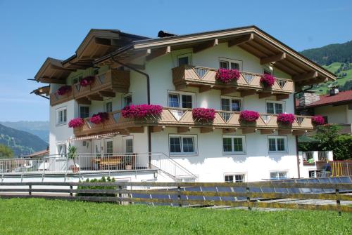 a building with flowers on the balconies at Appartements Olympia in Mayrhofen