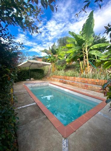 a swimming pool in the yard of a house at Pitalito - Mis Rokas Finca Campestre in Pitalito