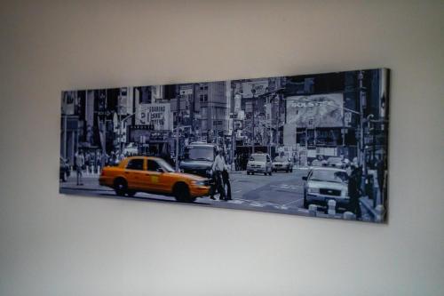 a black and white picture of a city street with a taxi at Couver House in Livingston