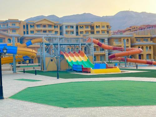 a water park with a water slide in front of a building at بورتو السخنه اكوا بارك in Ain Sokhna