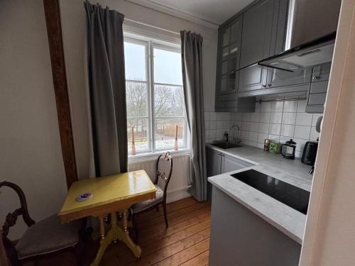 a small kitchen with a table and a sink at Hishult No 5 Hishults Prästgård in Hishult