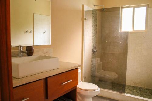 a bathroom with a sink and a toilet and a shower at Nosara Verde in Nicoya