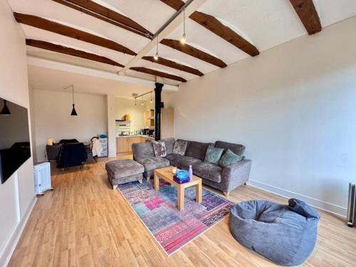 a living room with a couch and a table at William Bancroft Apartment in Nottingham