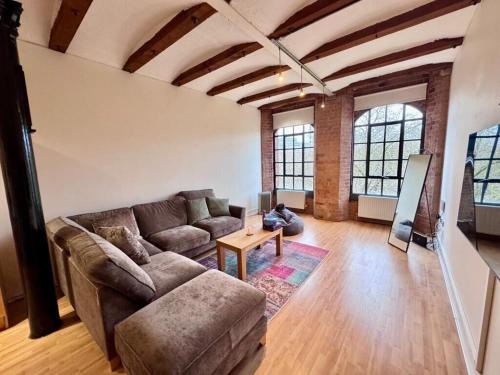 a living room with a couch and a table at William Bancroft Apartment in Nottingham
