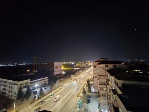 a city street at night with cars on the road at Petra's Skyline in Suceava