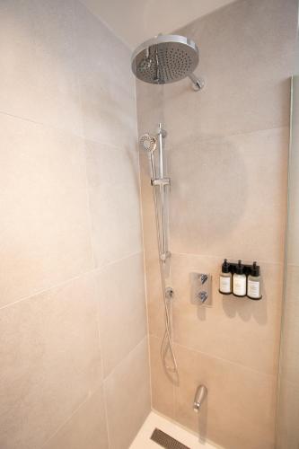 a shower with a shower head in a bathroom at Studio #1 - Self Check-In - Plateau - St-Denis in Montreal