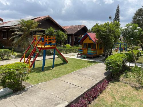 a playground with a slide and a house at Aconchego em Gravatá! Temporada in Gravatá