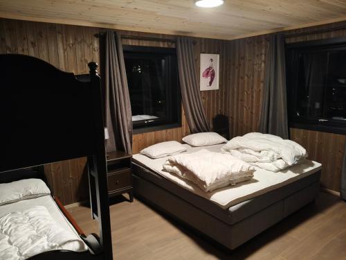 a bedroom with two beds and a window at Trysil turistesenter hytte in Trysil