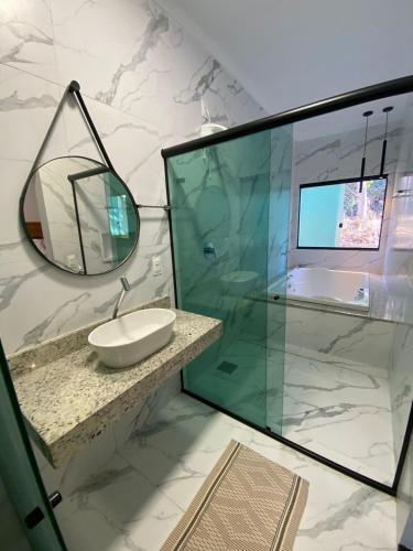 a bathroom with a sink and a mirror at Pousada Cigarras da Serra in Serra do Cipo