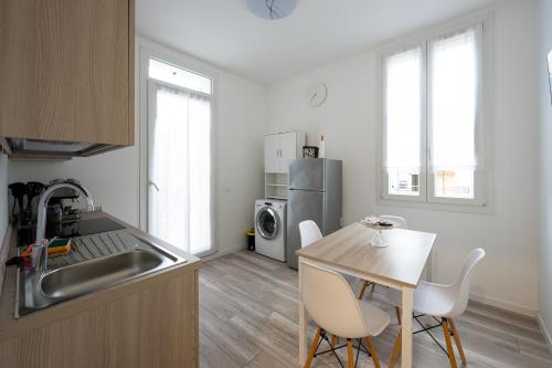 a kitchen with a sink and a table with chairs at casalami in Sanremo