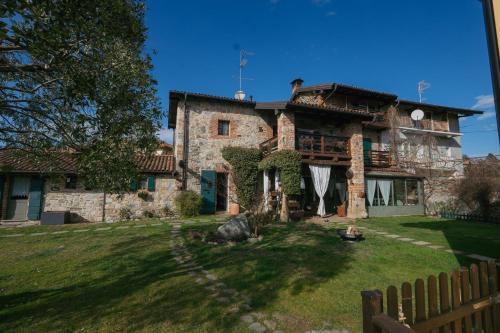 a large stone house with a yard at Il Salice B&B in Veruno