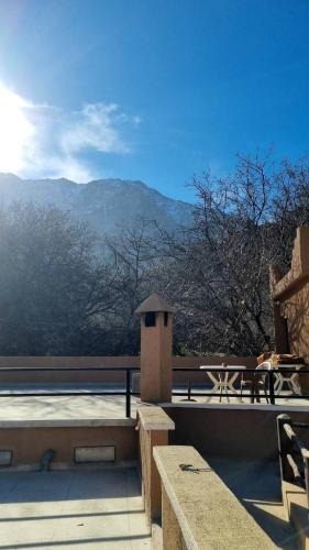 a patio with a table and a view of the mountains at Auberge De La Vallée in Imlil