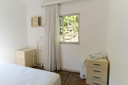 Ένα ή περισσότερα κρεβάτια σε δωμάτιο στο Refúgio no Jd. Botânico - Piscina, Sauna e Natureza