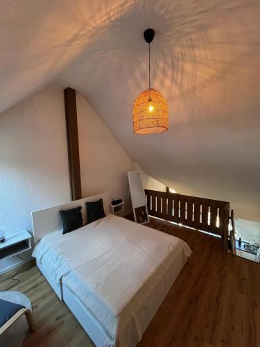 a bedroom with a white bed and a ceiling at Gemütliche Maisonette-Wohnung mit Balkon in Todtmoos