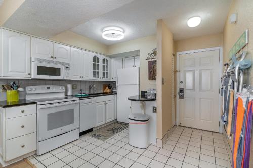 a kitchen with white cabinets and white appliances at Sands Beach Club 922 in Myrtle Beach