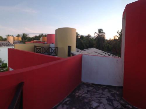 a view from the balcony of a building with a red fence at Paraíso de Maracajaú in Maxaranguape
