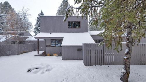 a house with snow on the ground in front of it at Meadow House - Unit 56 in Sunriver