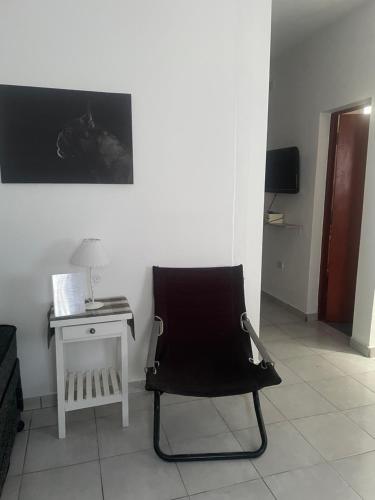 a black chair sitting in a room with a table at Departamento A&F II 1er piso Monoambiente 4 personas in San Fernando del Valle de Catamarca