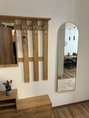 a mirror on a wall next to a table at Royal Gold & Spa Kop in Kopaonik