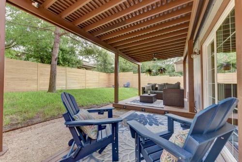 two blue chairs and a table on a patio at 3BR family home with backyard in Austin