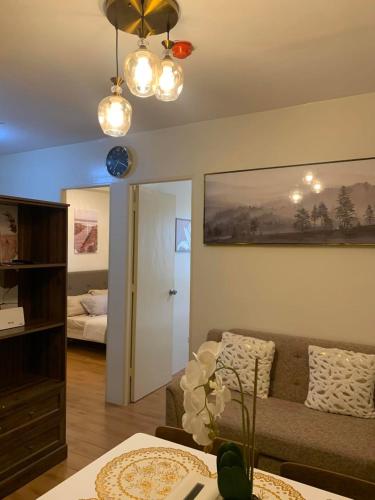 a living room with a couch and a bedroom at Seawind Condominium Near Airport in Davao City