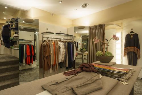 a dressing room with a rack of clothes at Suvretta House in St. Moritz
