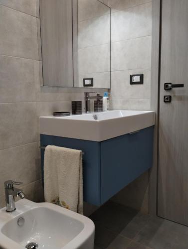 a bathroom with a white sink and a mirror at Appartamento Mare Blu in Martinsicuro