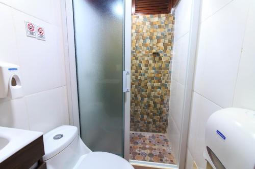 a bathroom with a shower with a toilet and a sink at Casa Lomas in Tegucigalpa