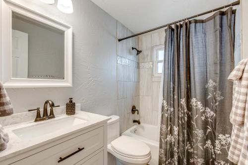 a bathroom with a sink toilet and a shower curtain at 12 Mi to Dtwn Denver Home with Fenced Backyard! in Northglenn
