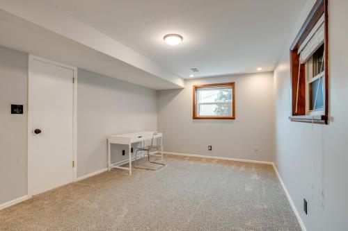 an empty room with a desk and a window at 12 Mi to Dtwn Denver Home with Fenced Backyard! in Northglenn