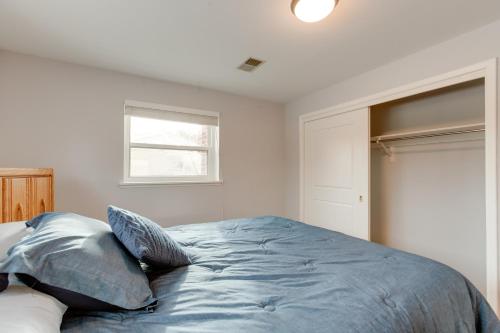 a bedroom with a bed with pillows on it at 12 Mi to Dtwn Denver Home with Fenced Backyard! in Northglenn