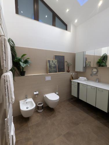 a bathroom with a toilet and a sink at Wald Villa Schönau in Schönau an der Brend