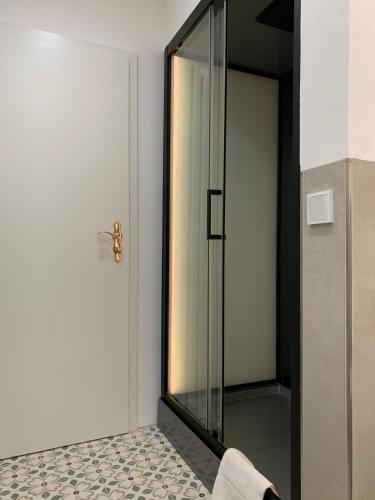 a glass shower door with a towel on the floor at Wald Villa Schönau in Schönau an der Brend