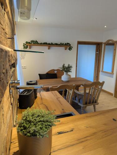 a living room with a table and a dining room at Wald Villa Schönau in Schönau an der Brend