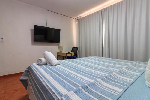 a bedroom with a bed with a teddy bear on it at Casa Lomas in Tegucigalpa