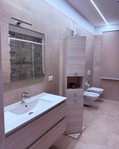 a bathroom with a sink and a toilet at Relais San Giovanni srls in Castellaneta