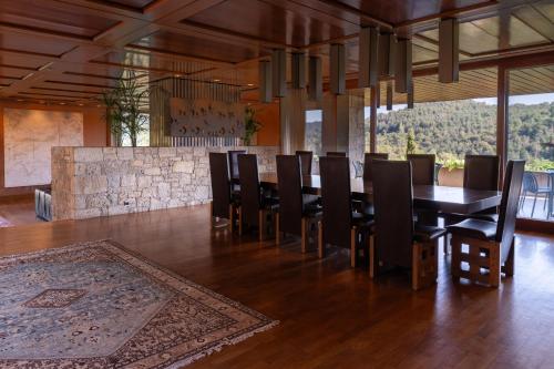 a dining room with a long table and chairs at Casakubrick mansión in Castelltersol