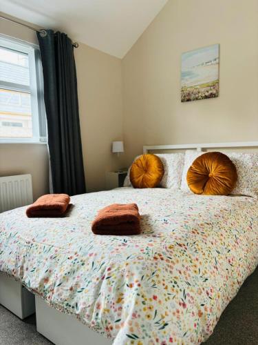 a bedroom with a bed with two pillows on it at Seascape Luxury sea front apartment in Bangor