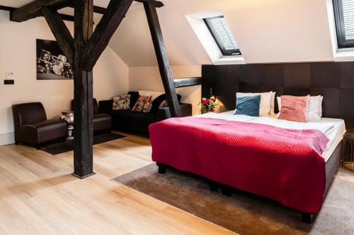 a bedroom with a large bed and a couch at Hotel Pałac Jugowice in Wałbrzych