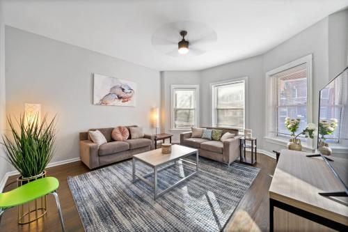 a living room with a couch and a table at Cozy Woodlawn Retreat 1 in Chicago