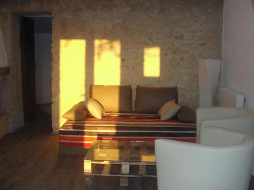 a living room with a couch and a window at Le Mas De La Chérine in Quinson