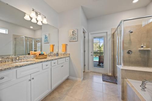 a bathroom with two sinks and a shower at The Orlando Oasis in Davenport