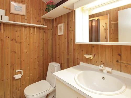 a bathroom with a sink and a toilet and a mirror at 10 person holiday home in Bindslev-By Traum in Bindslev